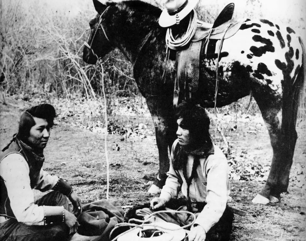 Dos hombres nez perce junto a un caballo appaloosa hacia 1895
